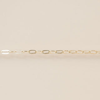 Gold chain on a beige background
