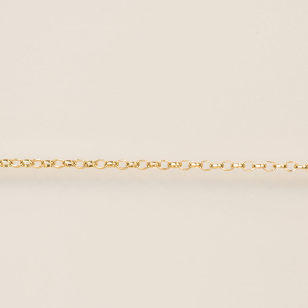 Gold chain on a beige background