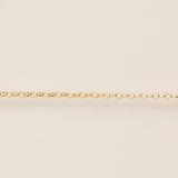 Gold chain on a beige background