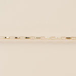 Gold bracelet on a beige background