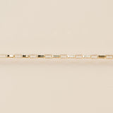 Gold bracelet on a beige background