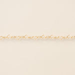 Gold bracelet on a beige background