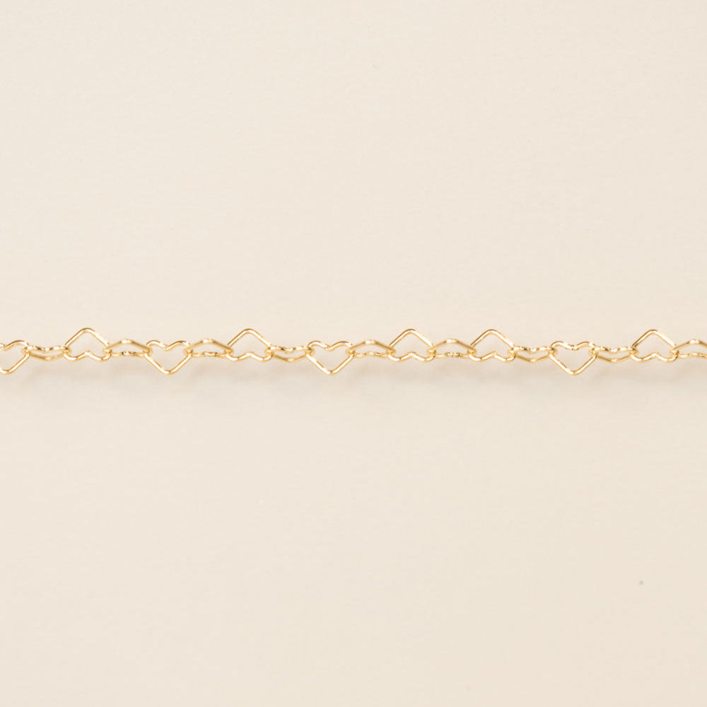 Gold bracelet on a beige background