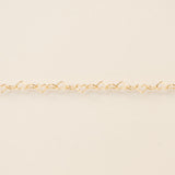 Gold bracelet on a beige background