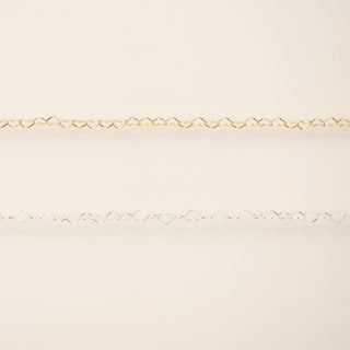 Gold chain on a beige background