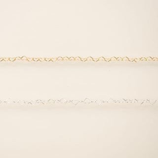 Gold chain on a beige background
