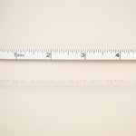 Beige fabric with a ruler at the top for scale