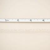 Beige fabric with a ruler at the top for scale