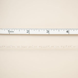 Beige fabric with a ruler at the top for scale