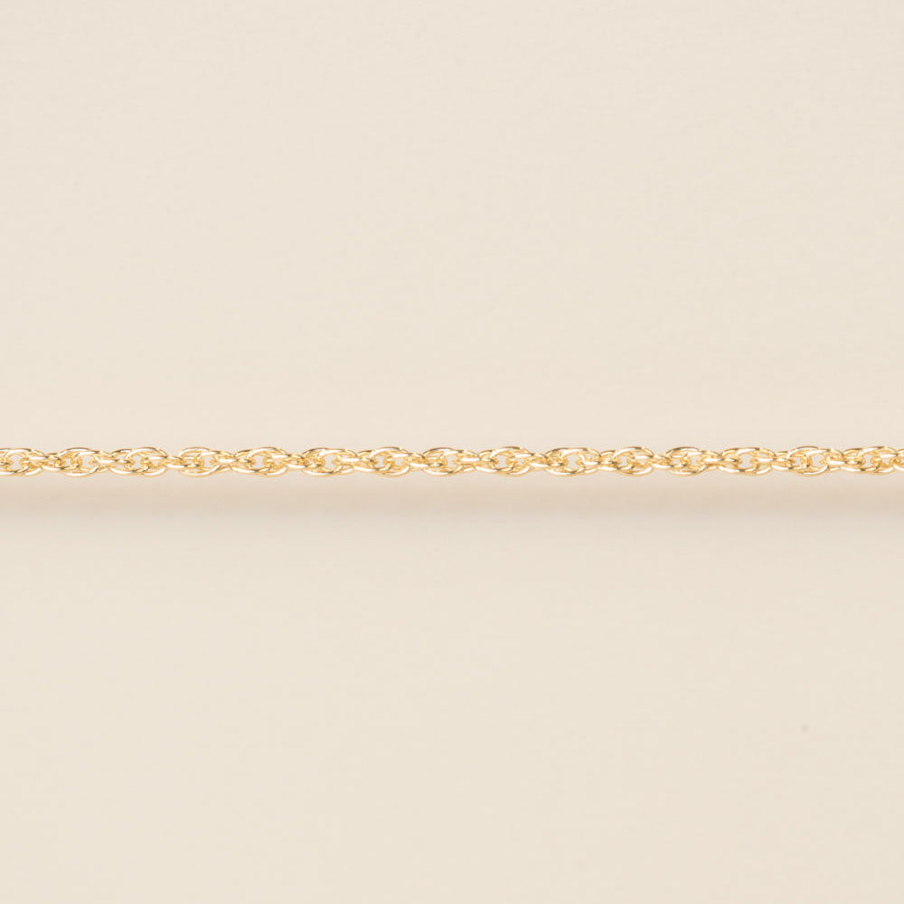 Gold chain on a beige background