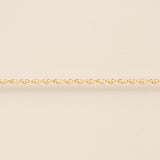 Gold chain on a beige background