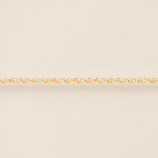 Gold chain on a beige background