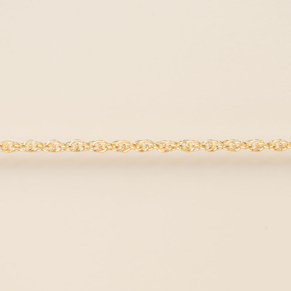 Gold chain on a beige background