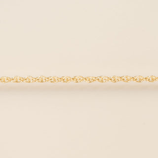 Gold chain on a beige background