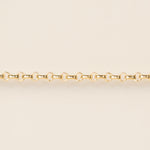 Gold chain on a beige background