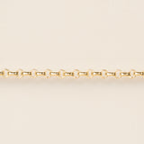 Gold chain on a beige background
