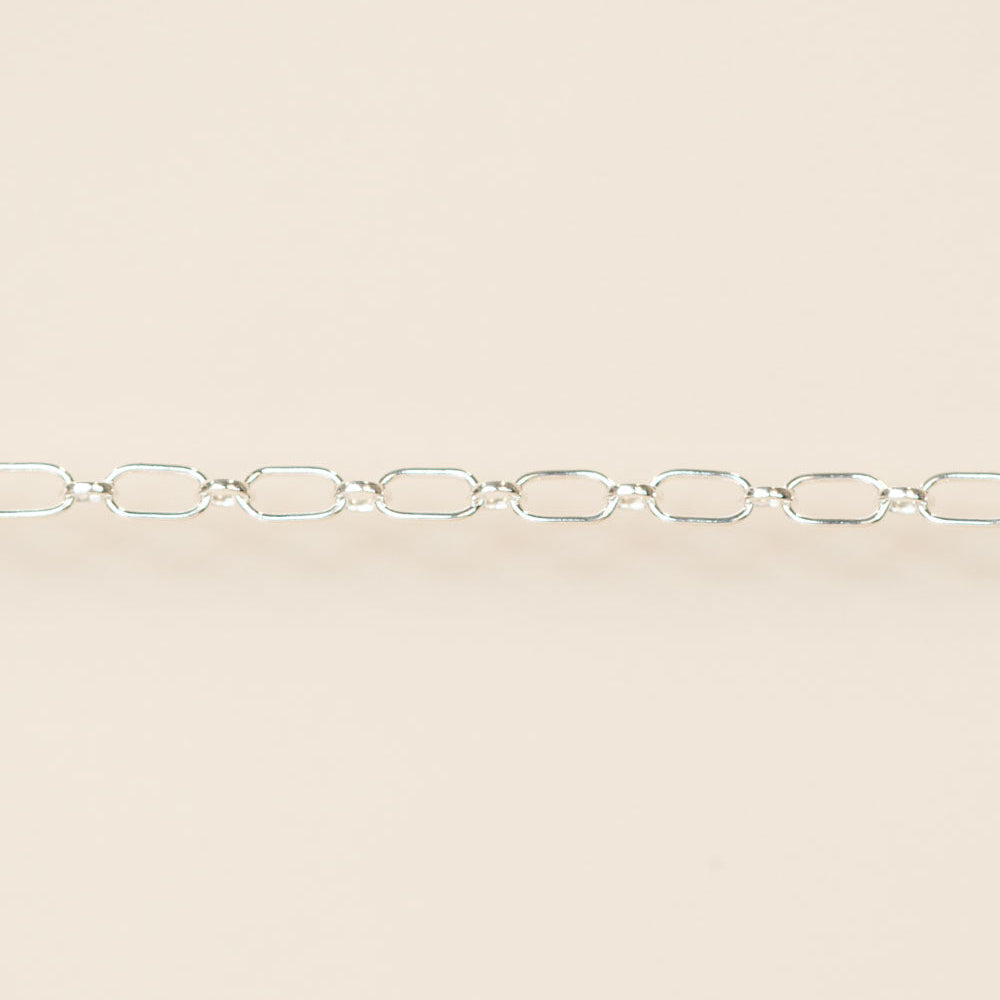 Silver chain on a beige background