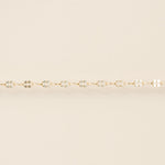 Gold bracelet on a beige background