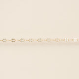 Gold bracelet on a beige background