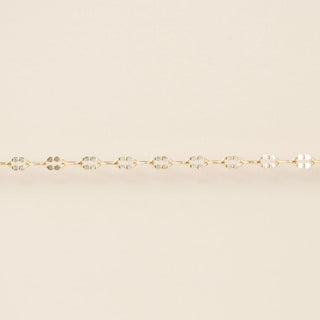 Gold bracelet on a beige background