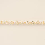 Gold bracelet on a beige background