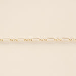Gold chain on a beige background