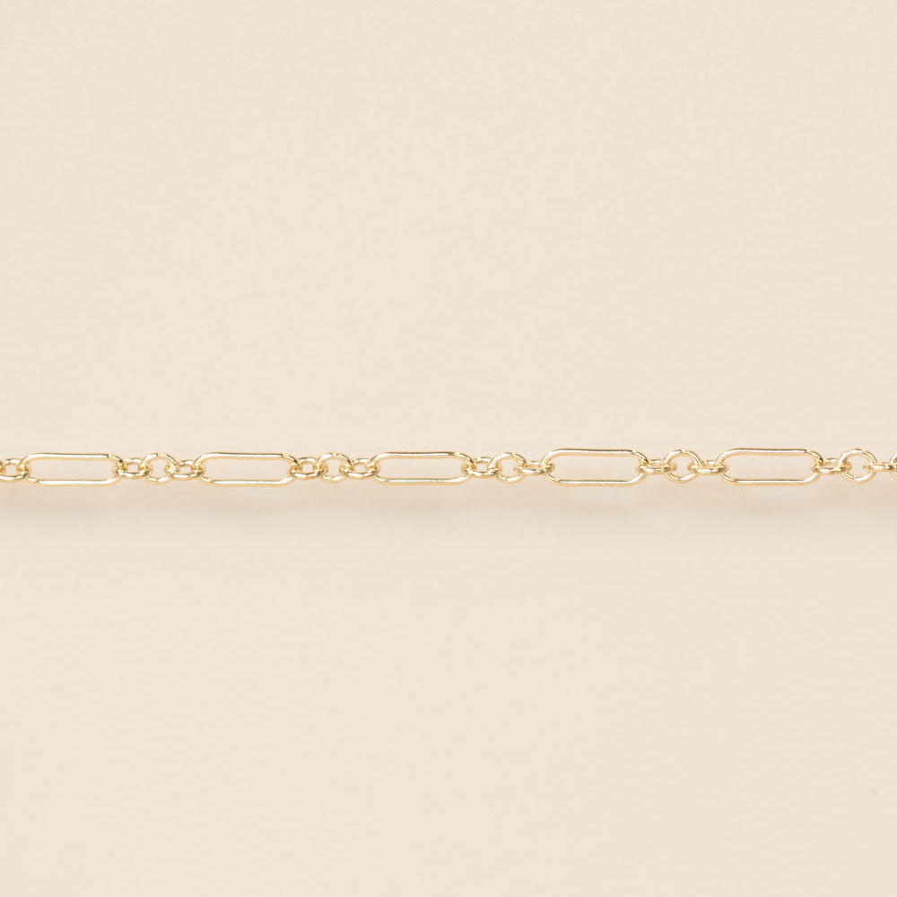 Gold chain on a beige background