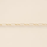 Gold chain on a beige background