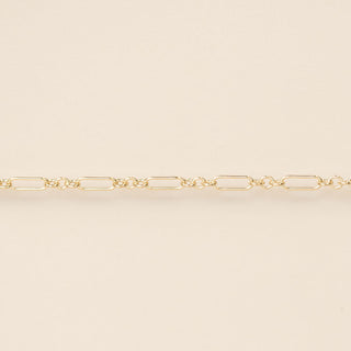 Gold chain on a beige background
