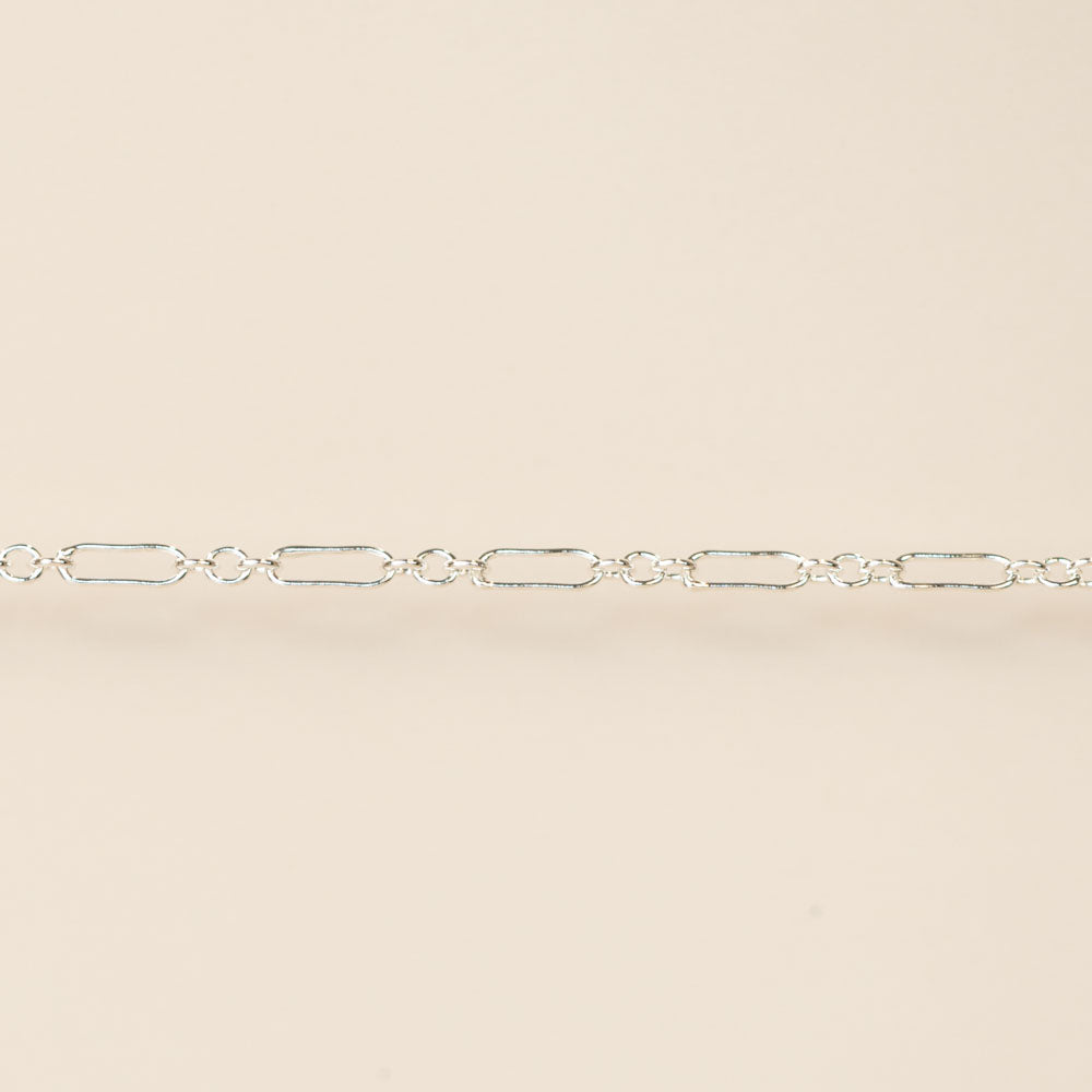Silver chain on a beige background