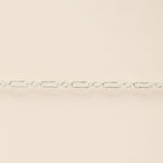 Silver chain on a beige background