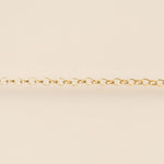 Gold chain on a beige background
