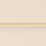 Gold chain on a beige background for permanent jewelry