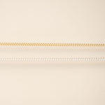 Two chains on a beige background gold and silver for permanent jewelry