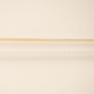 Two chains on a beige background gold and silver for permanent jewelry