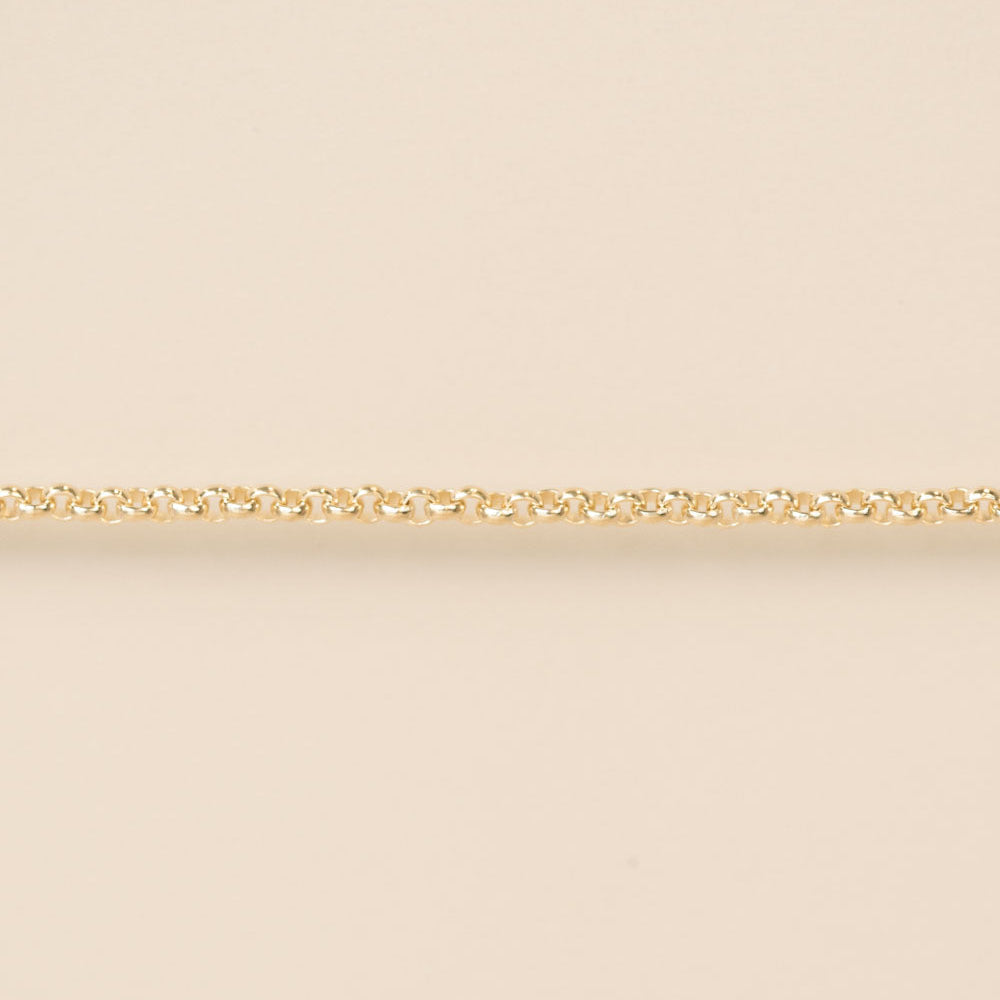 Gold chain on a beige background