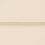 Gold chain on a beige background