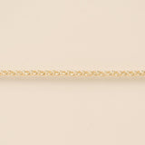 Gold chain on a beige background
