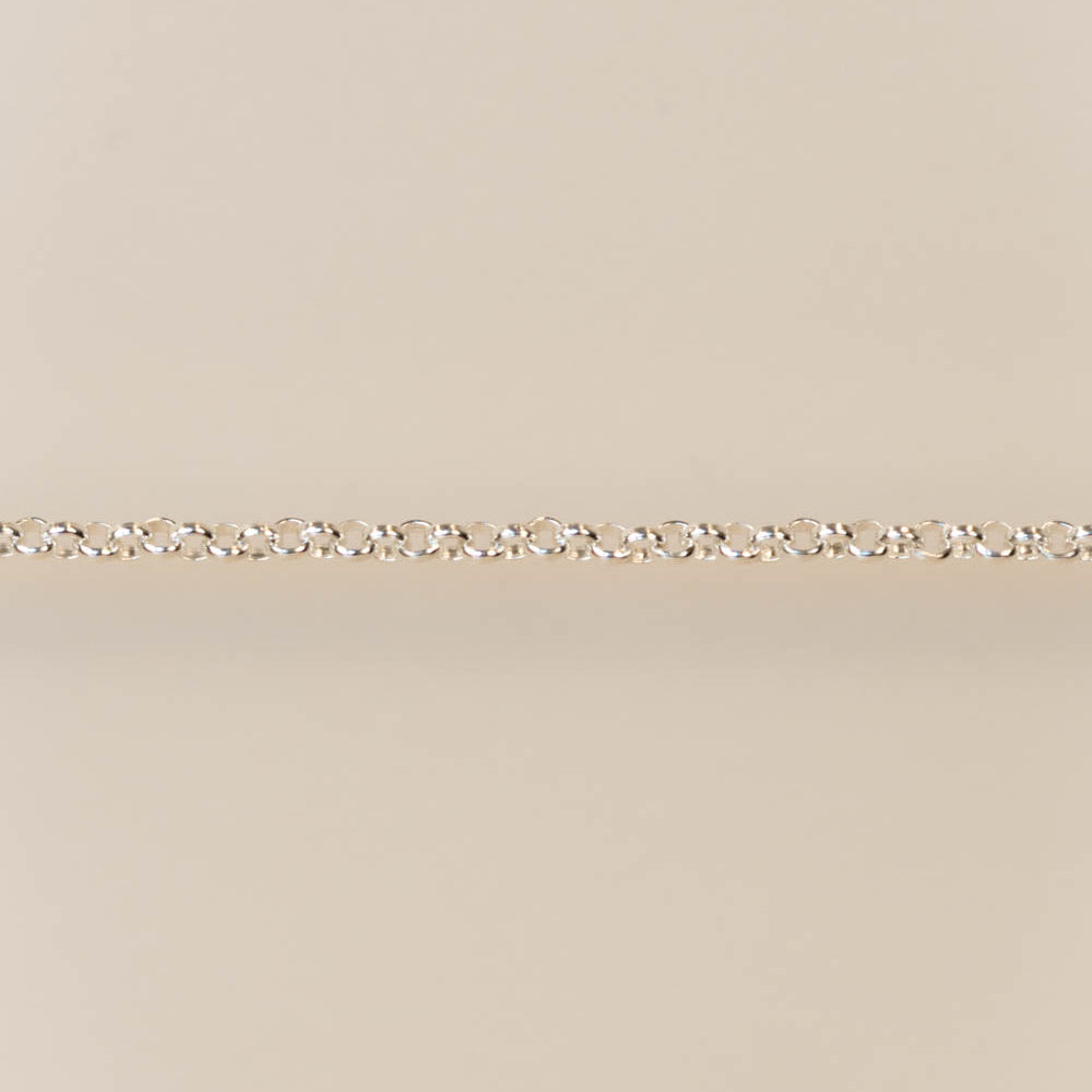 Gold chain on a beige background