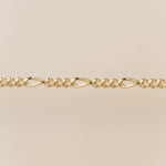 Gold chain bracelet on a beige background for permanent jewelry