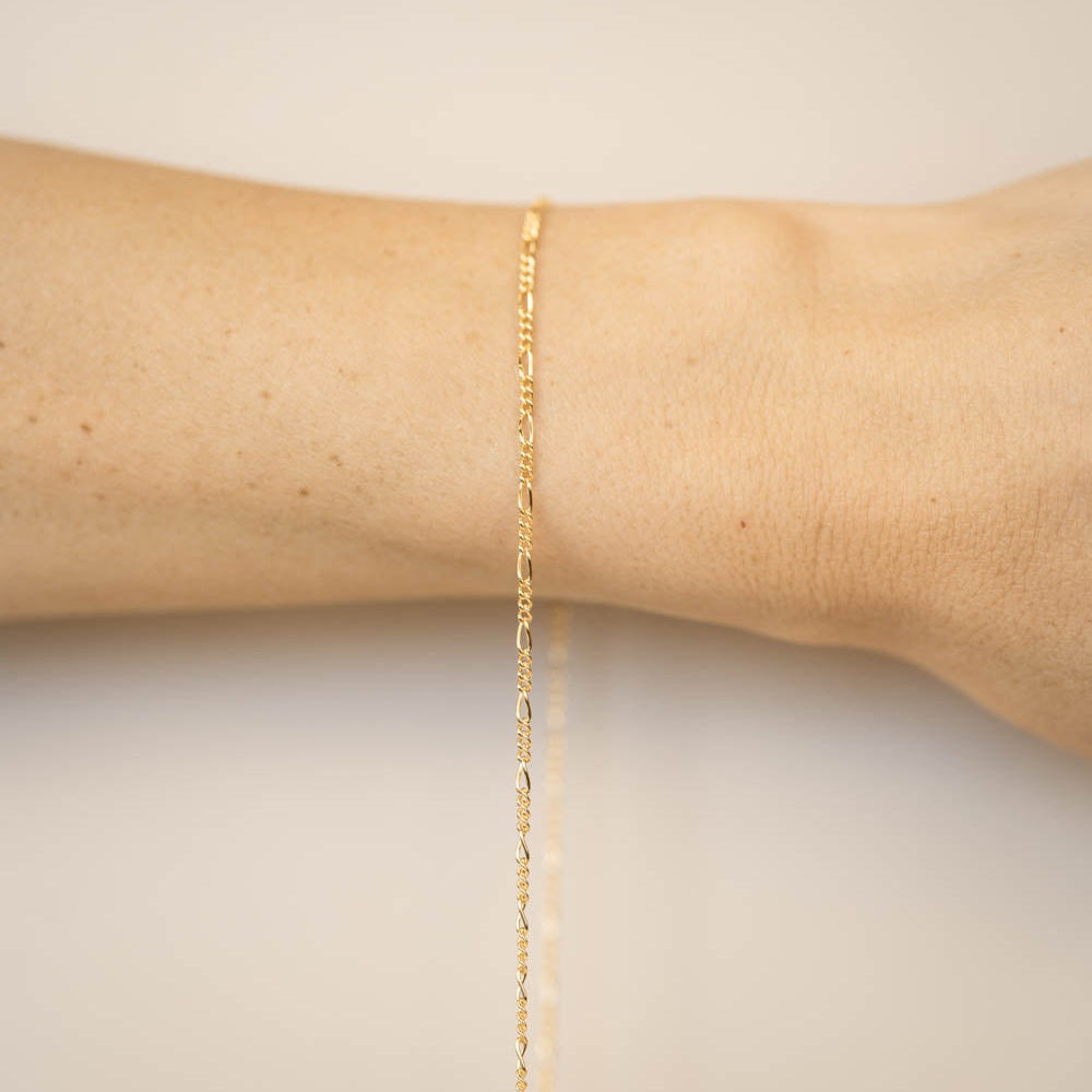 gold chain on wrist for permanent jewelry