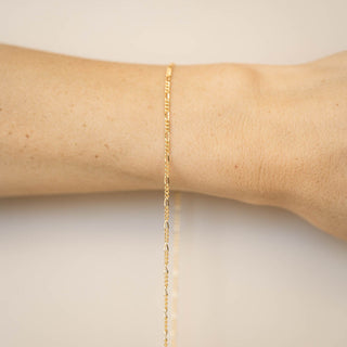 gold chain on wrist for permanent jewelry