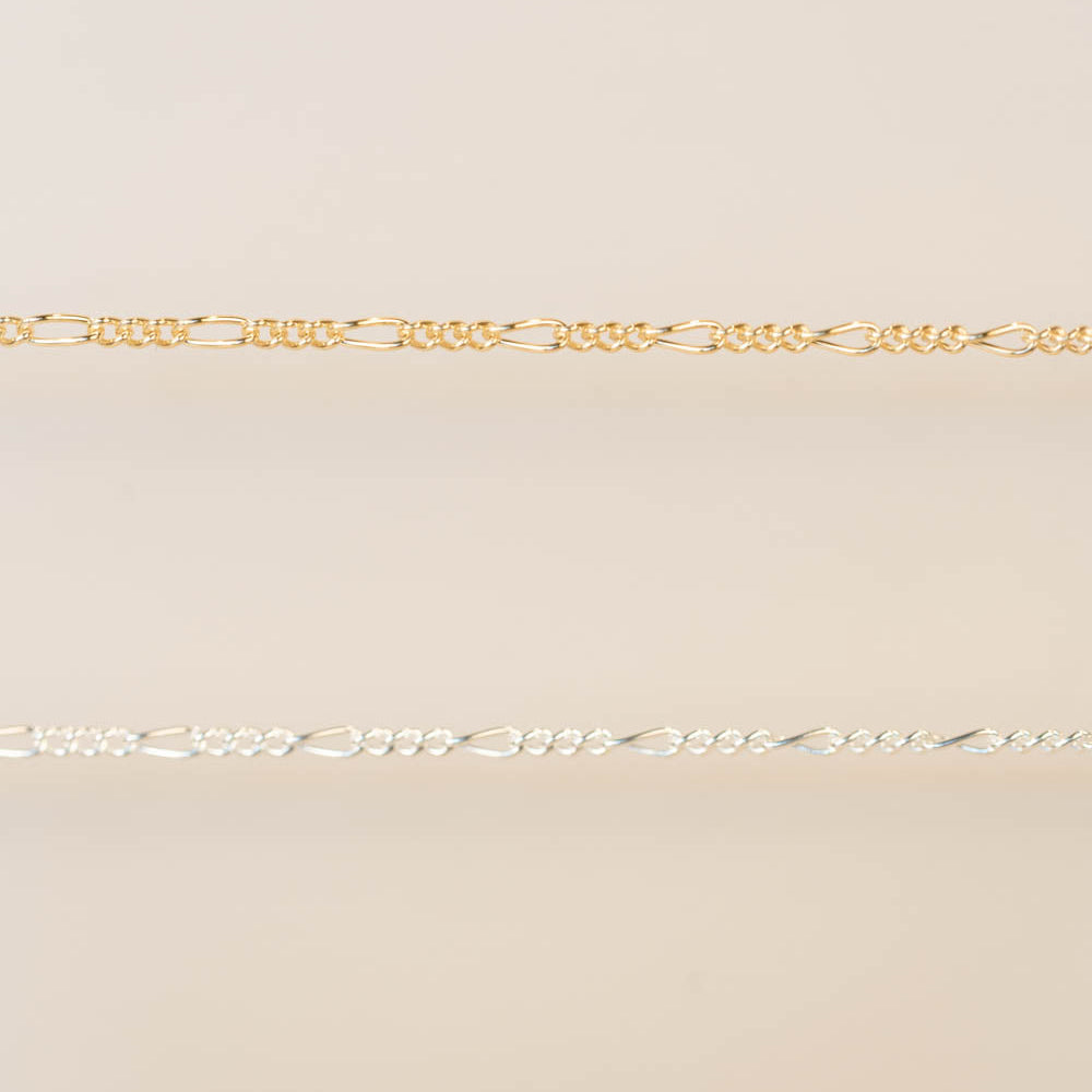 Gold chain on a beige background