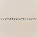Silver chain on a beige background