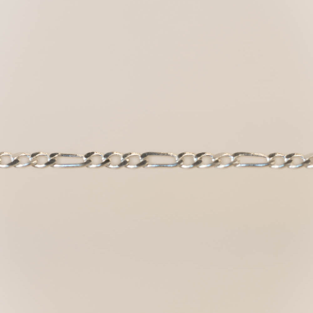 Silver chain on a beige background
