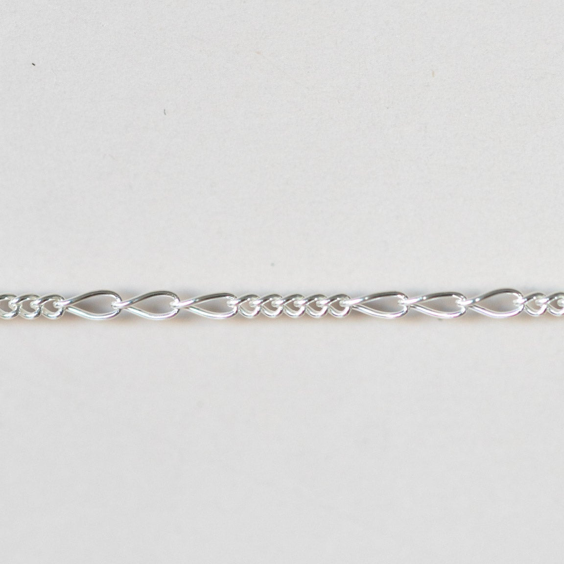 Silver chain on a light gray background