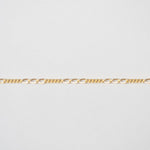 Gold chain on a light gray background
