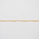 Gold chain on a light gray background