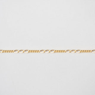 Gold chain on a light gray background