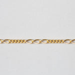 Gold chain on a light gray background